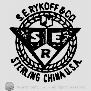 A triangle shape divided in 3 with SER written on it, over a circle shape frame with S. Erykoff & Co. written arched above and Sterling China U.S.A. written arched beneath