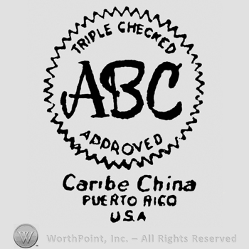 Triple Checked written arched above ABC written above Aproved written arched, all inside a serrated circle shape frame above Caribe China written above Puerto Rico written above U.S.A.