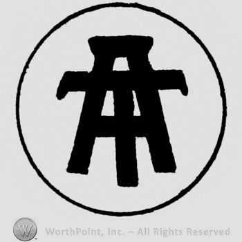 Letters A and T one over another in circle.