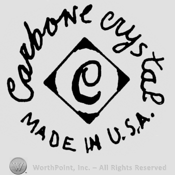 "Carbone Crystal" handwritten in lowercase letters, "Made in U.S.A." in uppercase letters and an uppercase "C" inside a diamond.