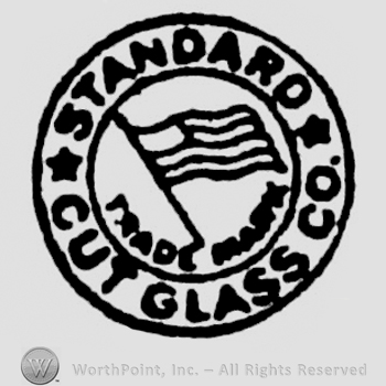 "Standard Cut Glass Co." written with uppercase letters around the American flag, all inside a circle