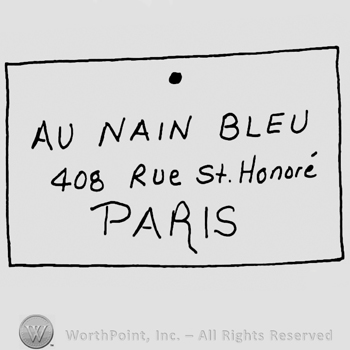 Au Nain Bleu with uppercase letters over 40B Rue St. Honore with lowercase letters, Paris written below with uppercase letters, all inside a rectangle