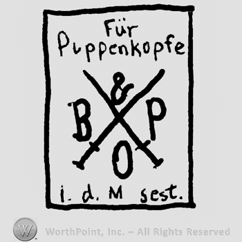 Crossed swords, uppercase B&P, Fur Puppenkopfe written with lowercase letters above, all inside a rectangle