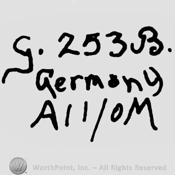 Uppercase handwritten G followed by number 243 and uppercase handwritten B, Germany written with lowercase letters over uppercase A, number 11 over 0 (zero) and uppercase M