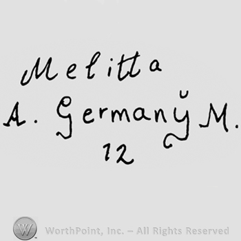 Melitta A. Germany M handwritten with lowercase and uppercase letters over number 12