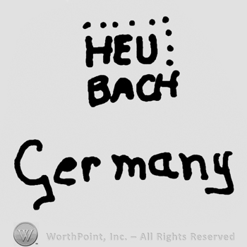 Heu Bach written with uppercase letters with two dotted lines above over Germany written with lowercase letters