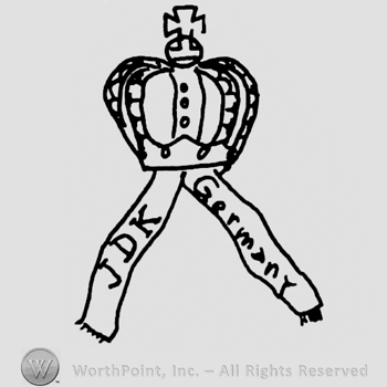Crown with cross above, two ribbons below, uppercase JDK on a ribbon, Germany written with lowercase letters on the other ribbon
