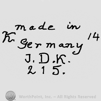 Made in Germany written with lowercase letters, precedeed by capital K and followed by number 14, uppercase J.D.K.written below alog with number 215