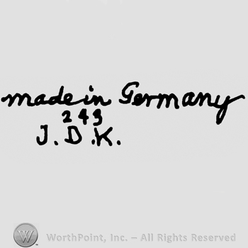 Made in Germany handwritten with lowercase letters over number 245 and uppercase J.D.K.