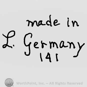 Made in Germany written with lowercase letters over number 141, uppercase handwritten L and number 15