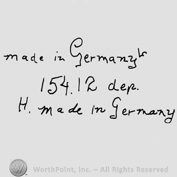 Made in Germany handwritten with lowercase letters over number 154.12 Dep, capital H and Made in Germany written with lowercase letters below