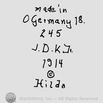 Made in Germany with lowercase letters precedeed by capital O and followed by number 18, over number 245 and uppercase J.D.K.J., number 1914, the Copyright symbol and Hilda written below with lowercase letters
