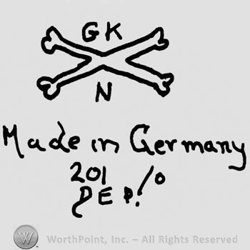 Uppercase G.K.over crossed bones, uppercase N below, Made in Germany written with lowercase letters over number 201/0, DEP with uppercase letters