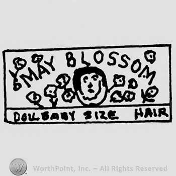 May Blossom writen with uppercase letters, flowers around it and Doll Baby Size Hair written below with uppercase letters, all inside a rectangle