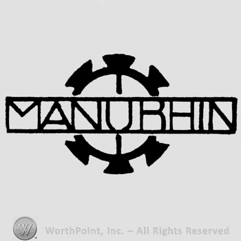 Bold circle and MANURHIN written over.