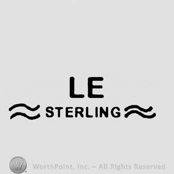 Letters LE above Sterling written between two curly lines.