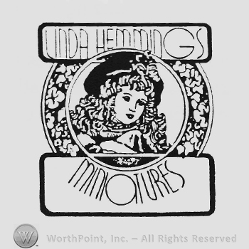 Labels Linda Hemmings up Miniatures down Doll face inside circular flower shape