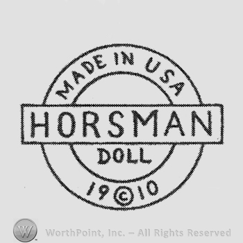 Rectangle with writing Horsman over a double circle on which are written: Made in USA above, 1910 bellow, Doll inside the circle
