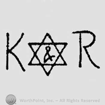 Symbol & inside a six angle star between capital K and R
