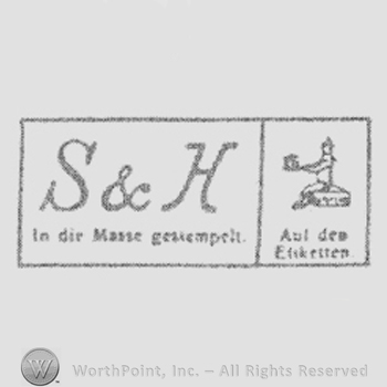 Initials S & H above writing, inside square. Small rectangle clived with a doll inside