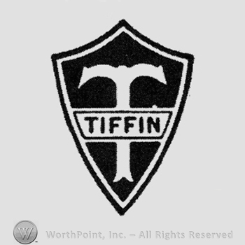 "Tiffin" written inside a white rectangle over initial "T", on a black shield
