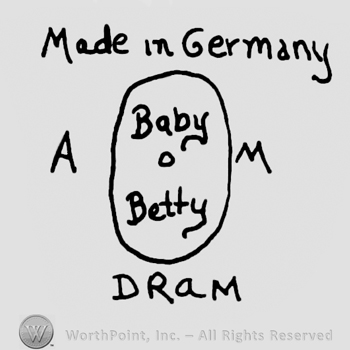 Made in Germany written with lowercase letters over an oval with Baby O Betty written inside, uppercase A and M written on the sides of the oval, uppercase DRAM written below