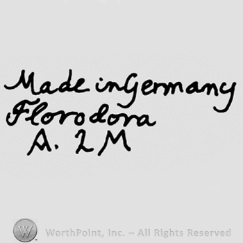 Made in Germany Florodora handwritten with lowercase letters over uppercase A, number 2 and uppercase M