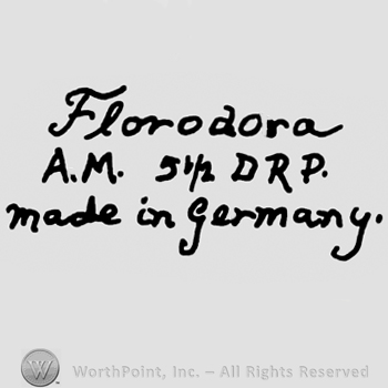 Florodora written with lowercase letters over uppercase A.M., number 5 1/2 and uppercase DRP, Made in Germany written below with lowercase letters