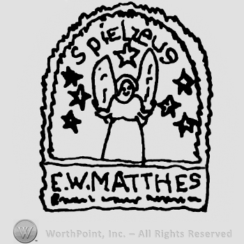 Stylized angel with stars around it, Spielzeus written with lowercase letters above, E.W. Matthes written below with uppercase letters, all inside an icon design