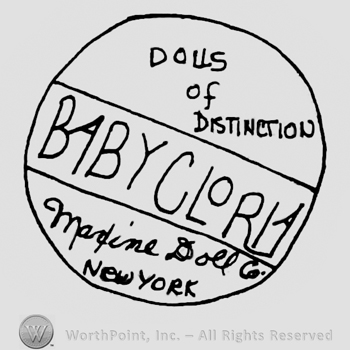 Baby Glory written with uppercase letters in the center of a circle, Dolls of Distinction written with uppercase letters on the upper half of the circle, Madine Doll Co. New York written with lowercase letters below