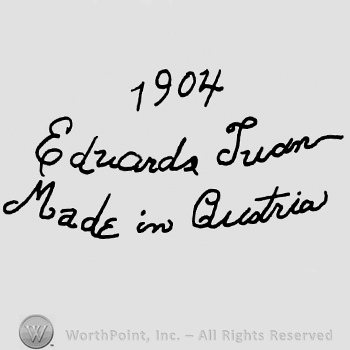 Number 1904 over Eduarda Juan Made in Austria handwritten with lowercase letters