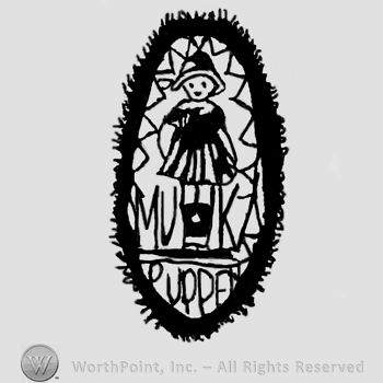 Oval ornamented design with standing stylized baby girl doll, Puppet written below with uppercase letters