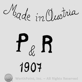 Made in Austria handwritten with lowercase letters over uppercase P&R and number 1907
