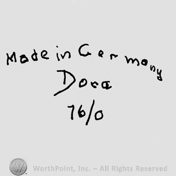 Made in Germany written with lowercase letters over Dora written with lowercase letters, number 16/0 written below