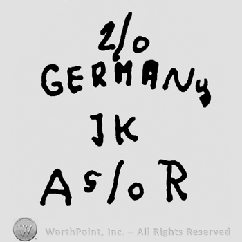 Number 2/0 over Germany written with uppercase letters, uppercase JK below, uppercase A and R framing number 5/0