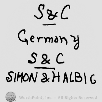 Uppercase S&C, underlined, over Germany written with lowercase letters, uppercase S&C underlined over Simon & Halbig written with uppercase letters