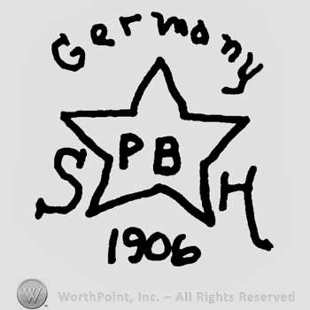 Germany written with lowercase letters over a star with uppercase PB written inside, uppercase S and H on the sides of the star, number 1906 written below