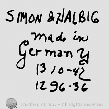 Simon & Halbig written with uppercase letters over Made in Germany handwritten with lowercase letters, Number 1310 minus 42, number 1269 minus 36