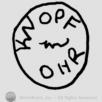 Circle with uppercase OPF and ONR, undescifrable writing in the center