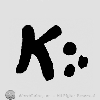 Letter K written next to three dots