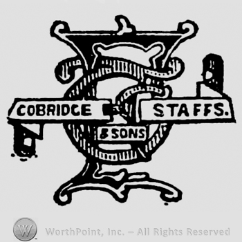 Monogram of initials in the centre. Ribbon with inscription over: Cobridge & Sons Stuffs