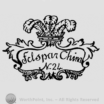 Felspar China N 24 written inside a frame made by leafs with initial M on the bottom. Crown above with three broad feathers raising out of it