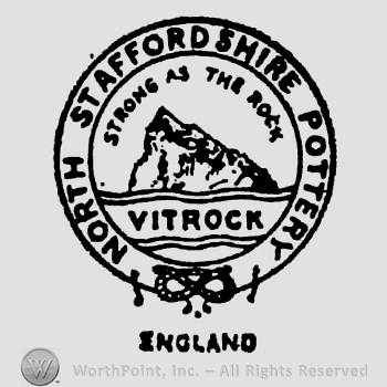 Strong as the Rock curved written above a rock, Vitrock written below between wavy lines. North Staffordshire Pottery written on the border. Staffordshire Knot on the bottom side of the border. England written beneath