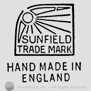 Hand Made in England written below on two rows. Sunfield Trade Mark written above, on two rows. Design of a sunshine on the upper left side, inside frame
