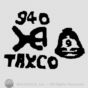 Number 940 over uppercase handwritten H and Taxco written with uppercase letters, bell on the right