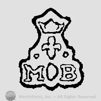 Crown above fleur de lis and two white pearls above letters M circle B