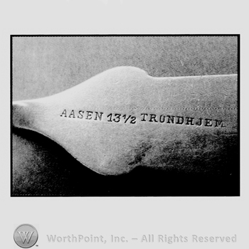AASEN 13 1/2 TRUNDHJEM written on a part of a silver object.