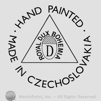 An acorn with uppercase D written on it, Royal Dux Bohemia written around it, all inside a triangle surrounded by the text Hand Painted Made in Czechoslovakia written in circle in uppercase letters.