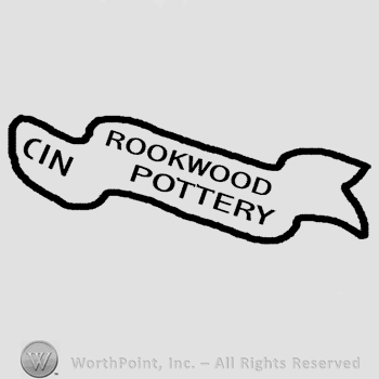 A ribbon with the text Cin Rookwood Pottery written in uppercase letters.