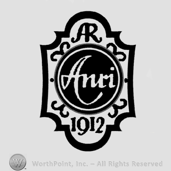 A cartouche with a circle and the word Anri written in the center, letters AR written above, number 1912 written below.